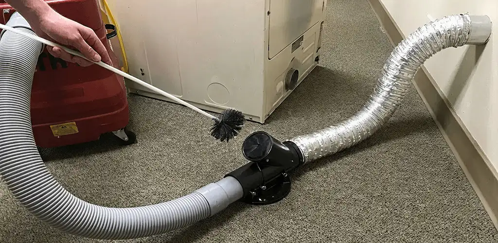 Dryer vent cleaning service removing lint from a dryer duct connection in Huntsville, AL