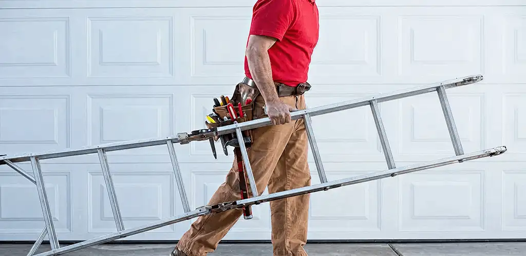 Garage door repair technician arriving with tools and ladder in Huntsville, AL